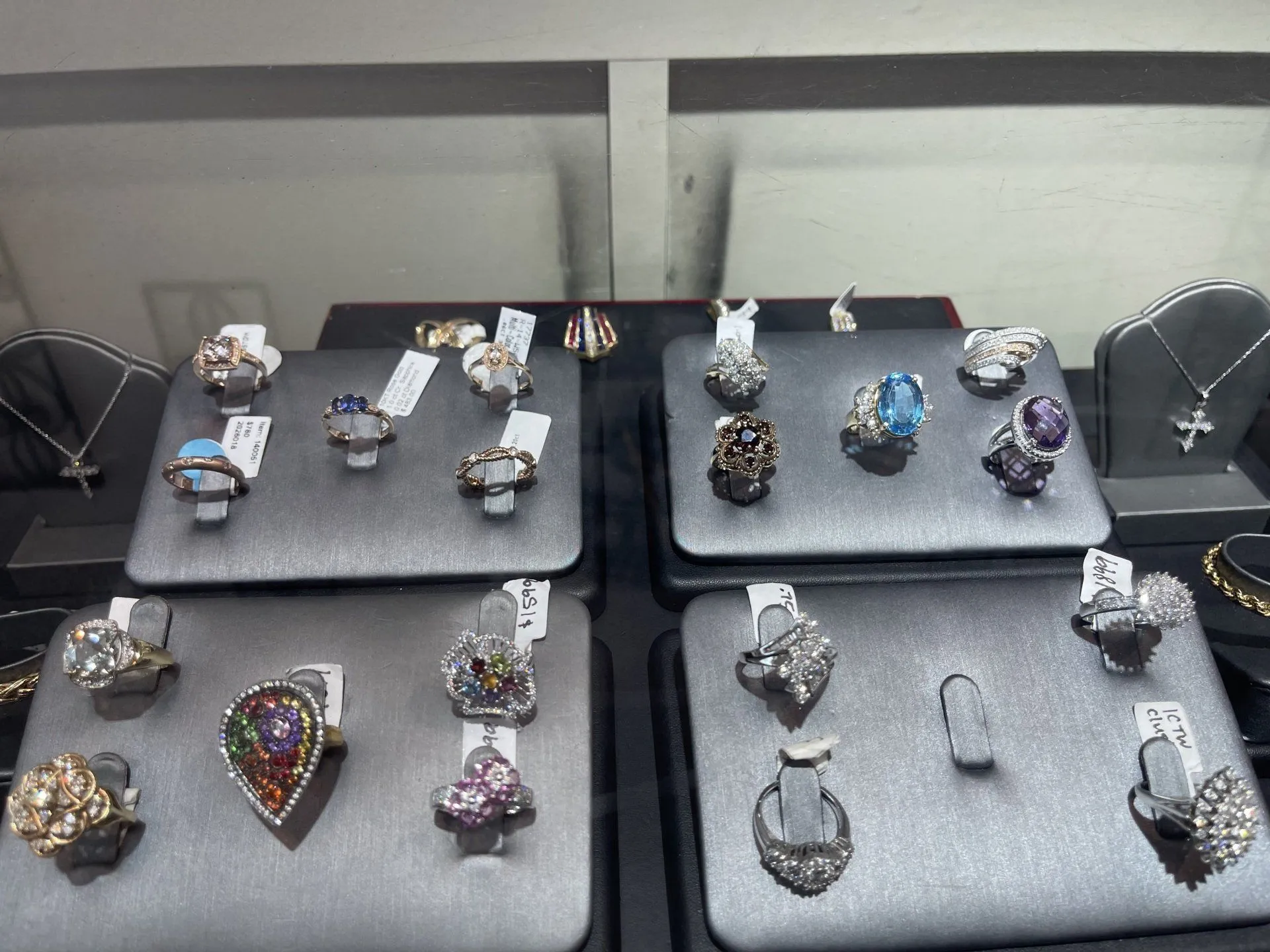 Showroom case of colored-gemstone rings, topaz, amethyst and sapphire