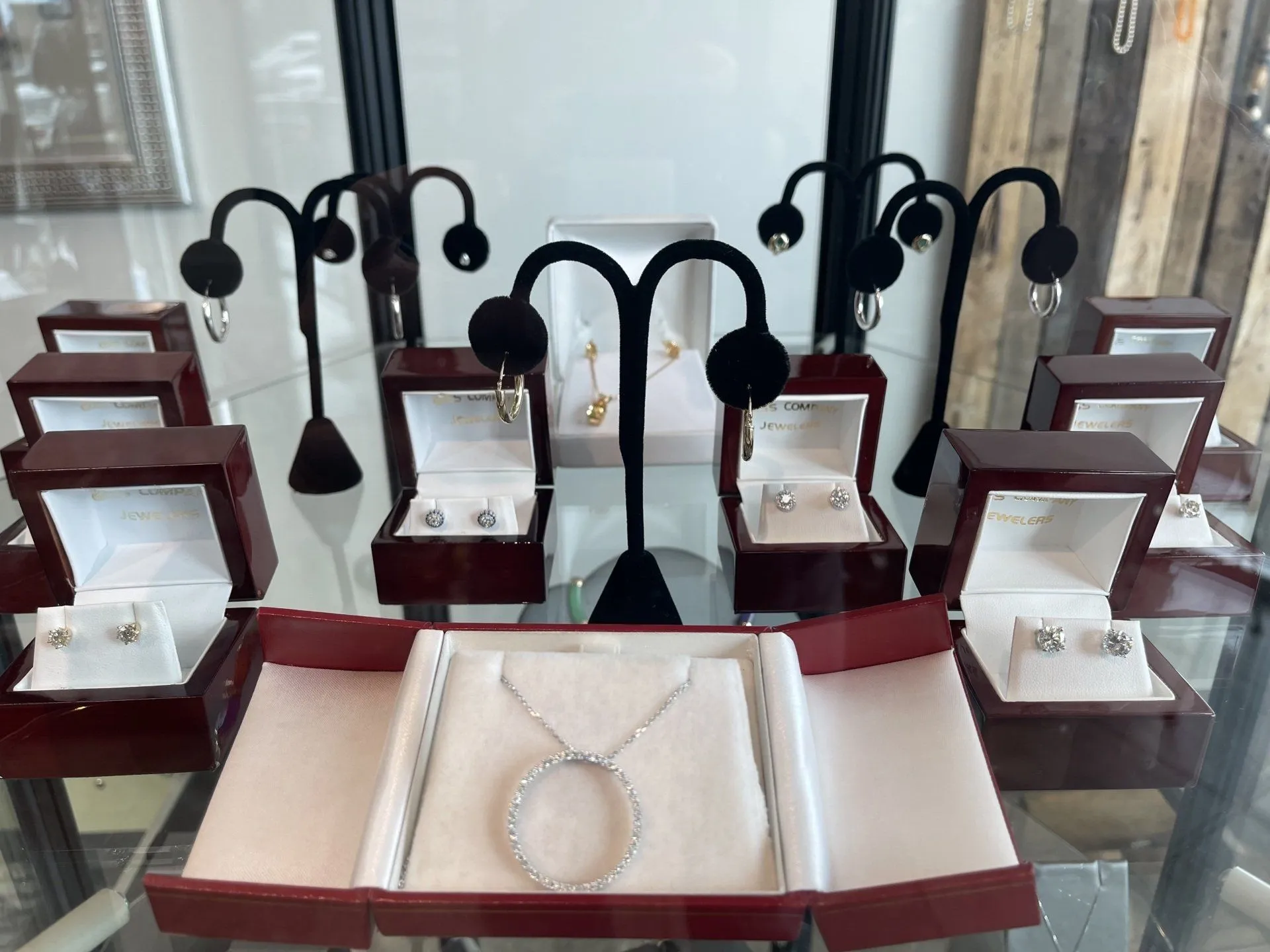 Case of 14k gold hoop earrings in presentation boxes