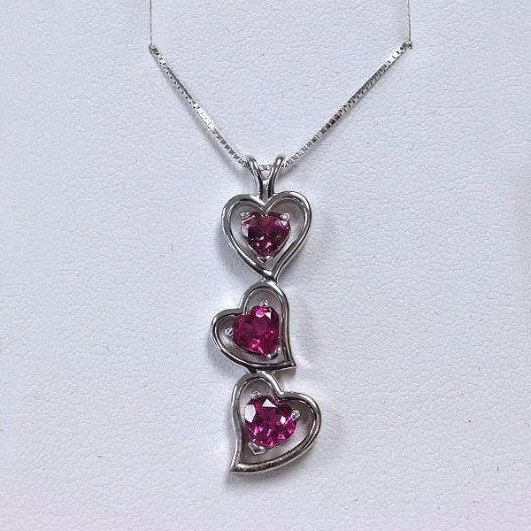 Sterling silver pendant with three pink gemstone hearts